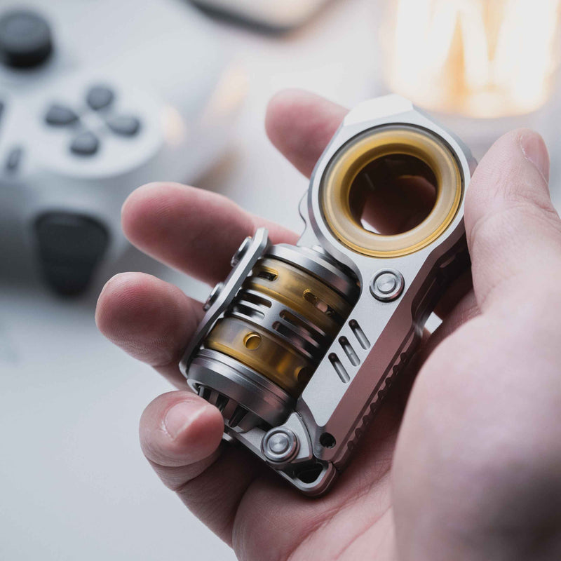 Silver and brass Sinian mechanical fidget slider held in hand